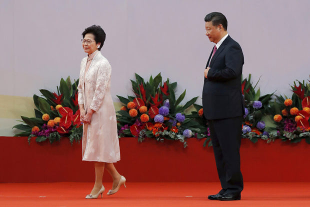 China blinks on Hong Kong, but divide remains