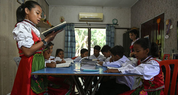 Teacher teaching Kristang