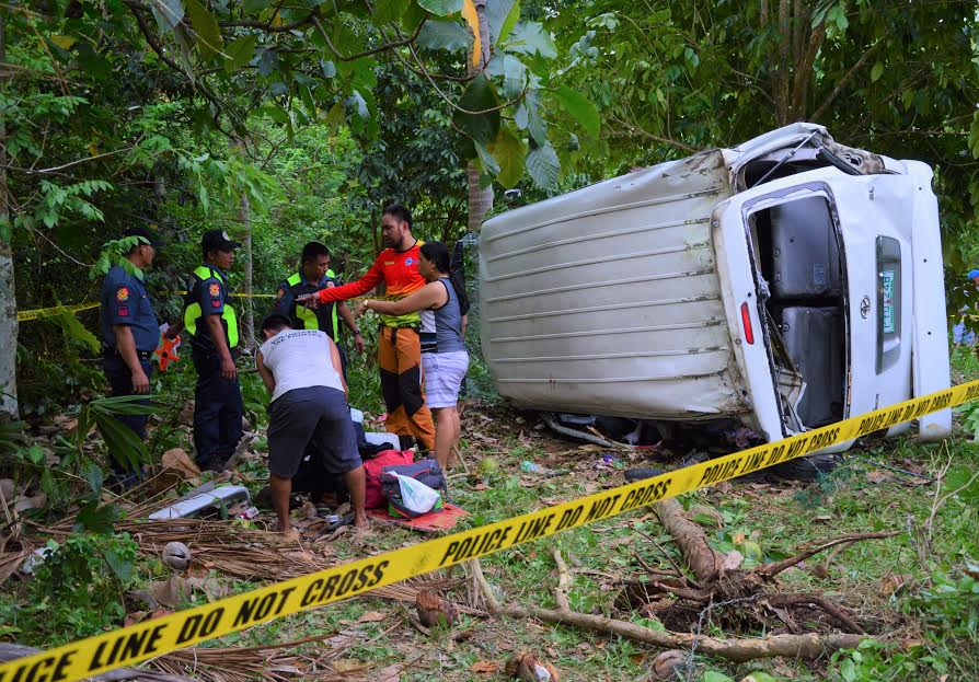 Officers from the Mambajao Police Municipal Station in Mambajao, Camiguin, check the site of the van that figured in an accident in said town late Saturday afternoon. Three passengers were killed in the crash. (Jigger J. Jerusalem)