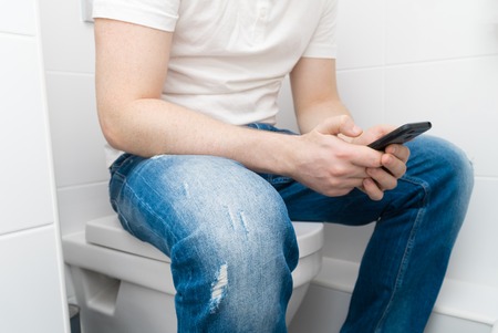 man sitting on a toilet