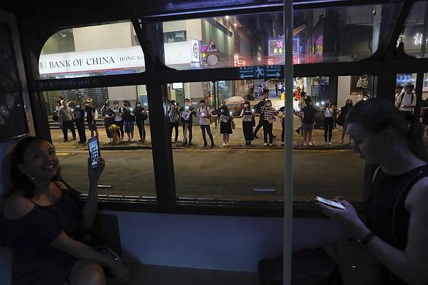 Hong Kong protesters on sidewalk seen from tram