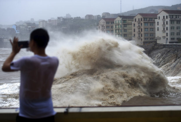 Chinese state TV: At least 18 dead in typhoon, 14 missing