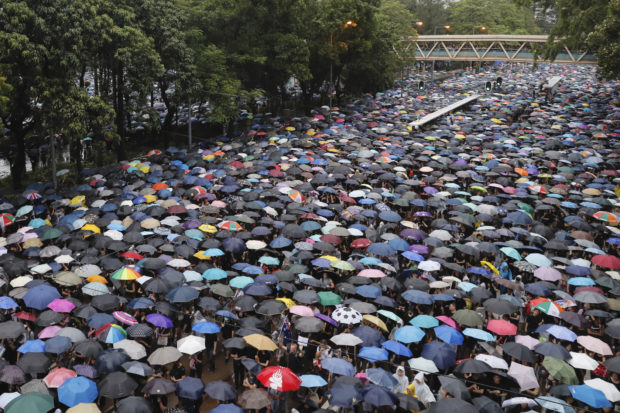  Police keep low profile at huge, peaceful Hong Kong protest