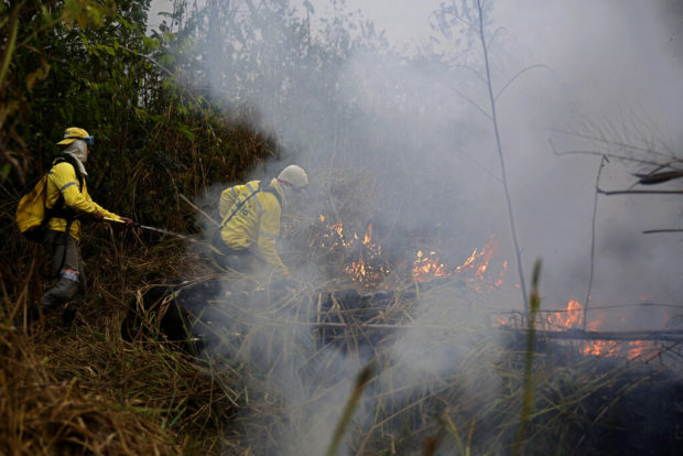 Brazilian firefighters toil in Amazon region hazy with smoke