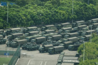 Thousands of Chinese military personnel paraded at a sports stadium in a city across the border from Hong Kong on Thursday, an AFP reporter witnessed.