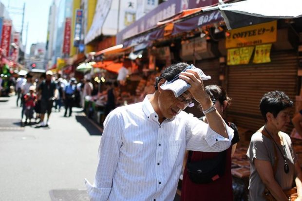 Japan on typhoon watch as heatwave death toll climbs