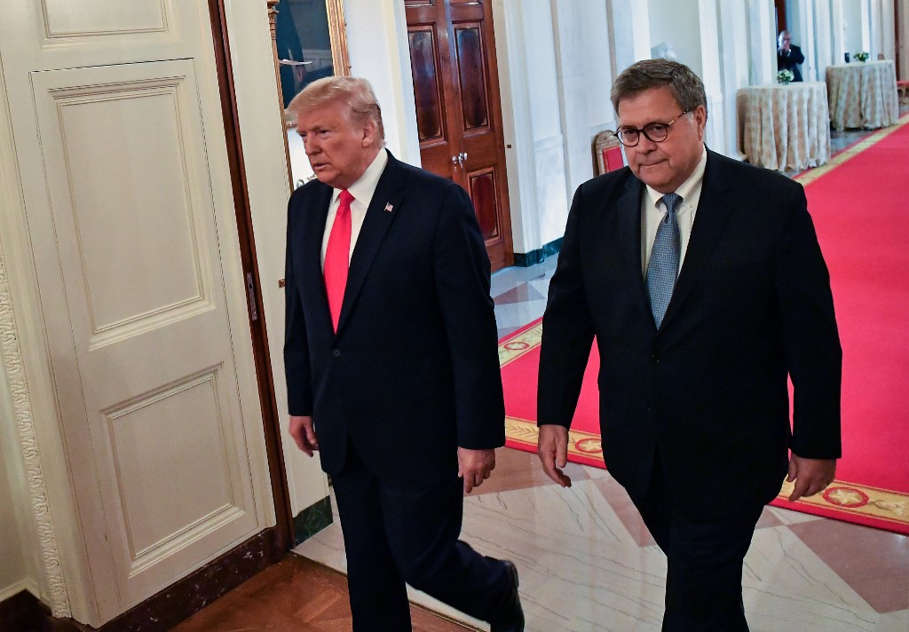 US President Donald Trump (L) and Attorney General William Barr arrive to present the Medal of Valor and Heroic Commendations to officers and civilians who responded to mass shootings in Dayton, Ohio and El Paso, Texas, in the East Room of the White House in Washington, DC on September 9, 2019. (Photo by NICHOLAS KAMM / AFP)