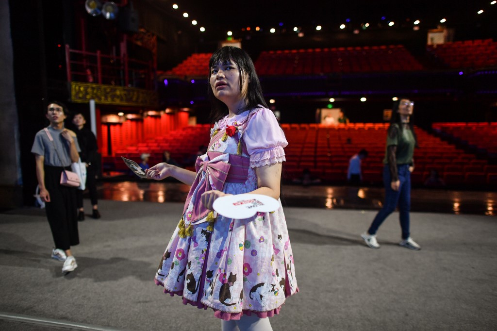 This photo taken on August 30, 2019 shows transgender Alice (C), a member of the Trans Chorus, during rehearsal at a theatre one day before the group's musical presentation at a festival in the city of Chengdu in China's Sichuan province. - In China, where no official numbers of transgender people exist, there are few medical facilities that offer gender reassignment surgery and little professional information on hormone treatment, forcing people to turn to the black market or online. (Photo by HECTOR RETAMAL / AFP) / TO GO WITH China-health-transgender,FOCUS by Pak YIU