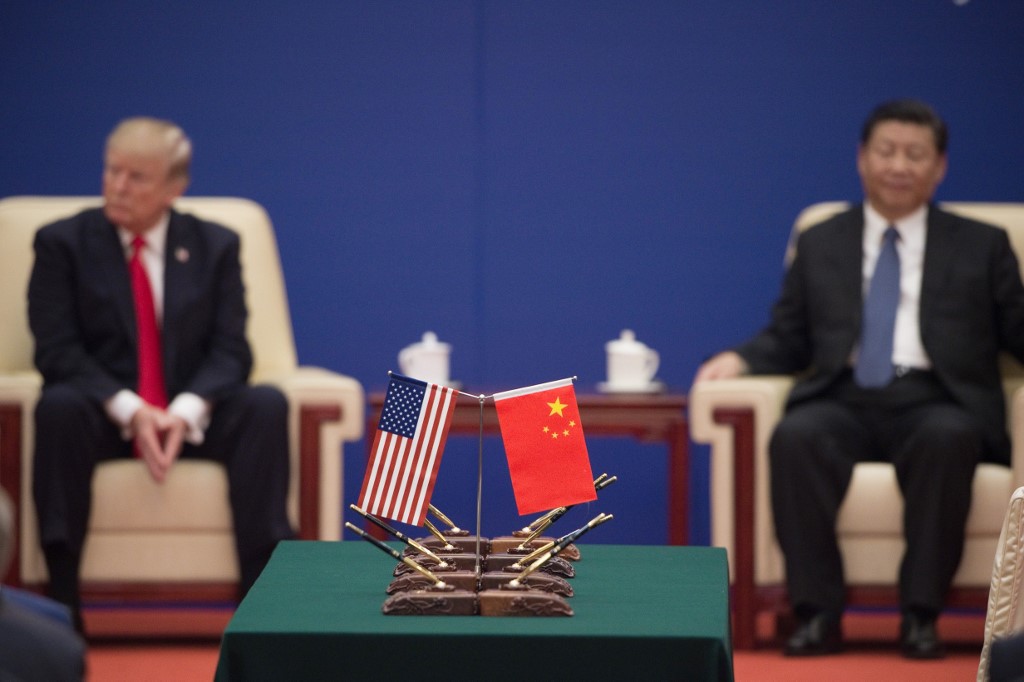 (FILES) In this file photo taken on November 9, 2017 US President Donald Trump (L) and China's President Xi Jinping attend a business leaders event inside the Great Hall of the People in Beijing. - US President Donald Trump will stand before the United Nations on September 24, 2019, to declare his country top of the world. But with diplomatic troubles building, his annual boast may ring hollow. Trump's political brand is as well known inside the United Nations as his businessman version is to the rest of New York: brash, unabashedly self-promoting, and all about claiming the win. (Photo by Nicolas ASFOURI / AFP)