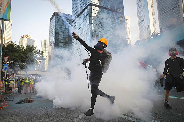 Hong Kong protesters throws back teargas cannister