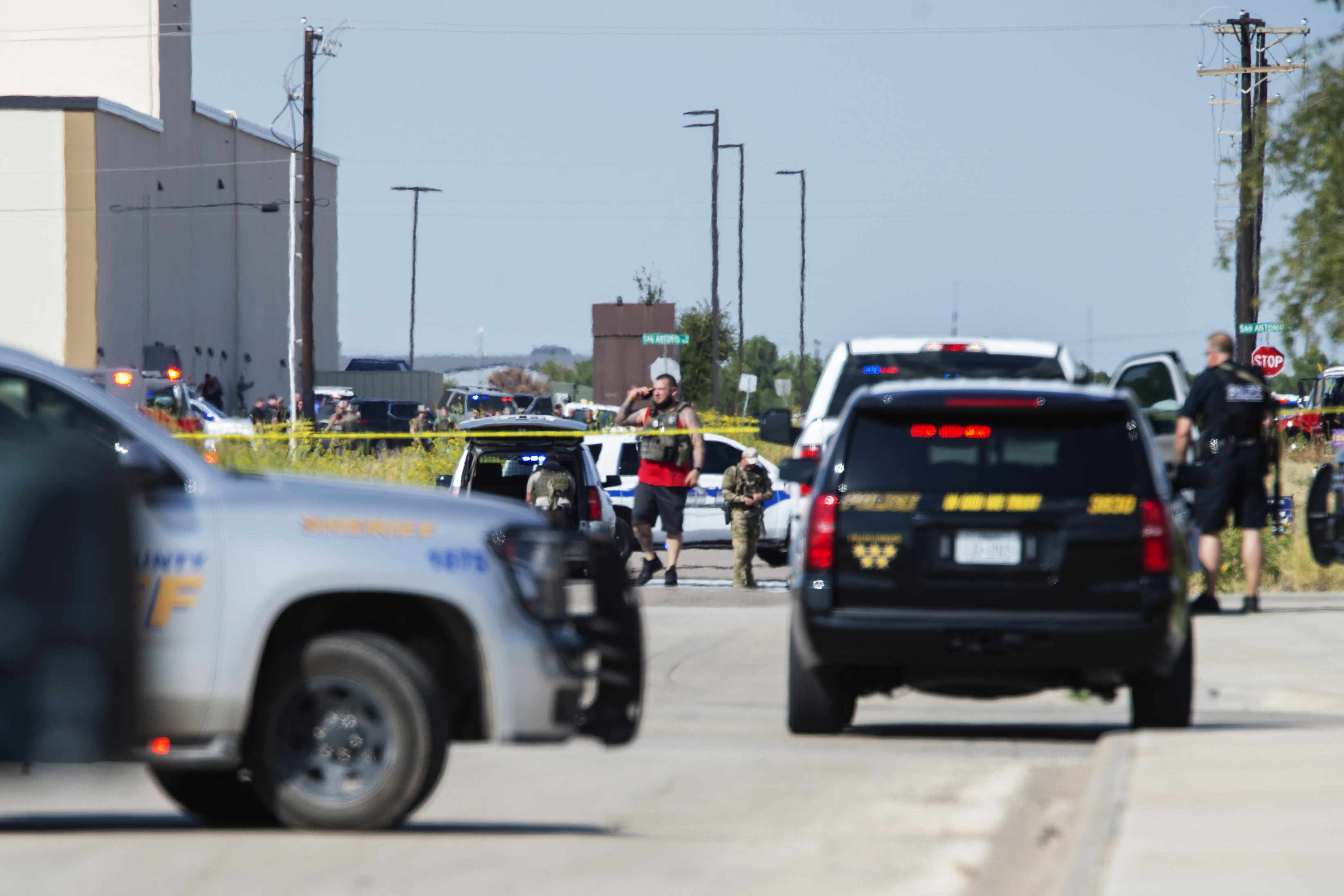 texas shooting CORRECTS THE NAME OF THE SOURCE TO THE MIDLAND REPORTER-TELEGRAM - Odessa and Midland police and sheriff's deputies surround the area behind Cinergy in Odessa, Texas, Saturday, Aug. 31, 2019, after reports of shootings. Police said there are "multiple gunshot victims" in West Texas after reports of gunfire on Saturday in the area of Midland and Odessa. (Tim Fischer/Midland Reporter-Telegram via AP)