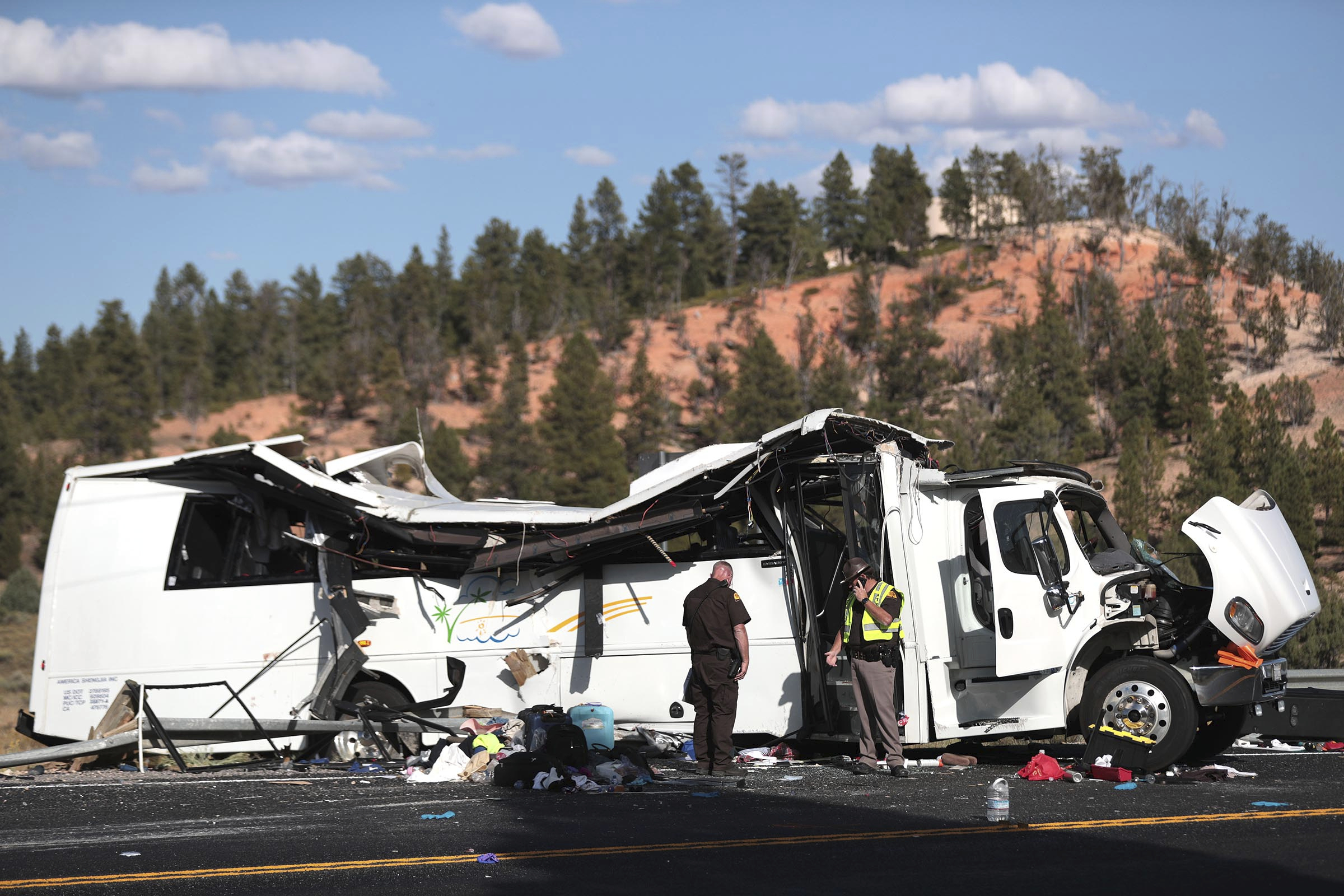 Authorities work the scene where at least four people were killed in a tour bus crash near Bryce Canyon National Park, Friday, Sept. 20, 2019, in Utah. (Spenser Heaps/The Deseret News via AP)