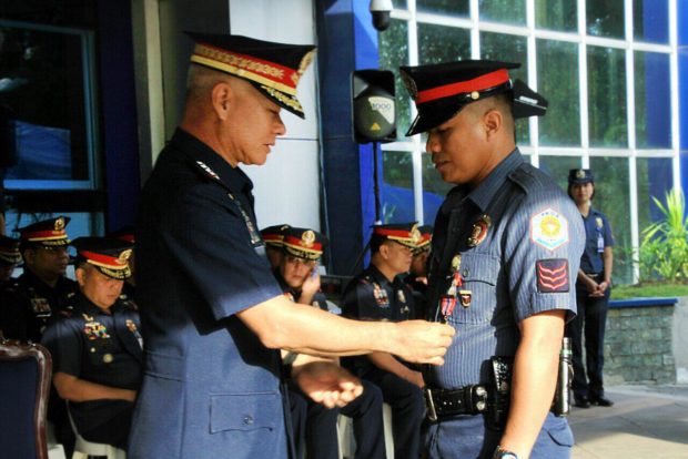 PNP chief Gen. Oscar Albayalde confers the PNP Heroism Medal to two police officers who helped rescue passengers of the M:B Chi-Chi 1