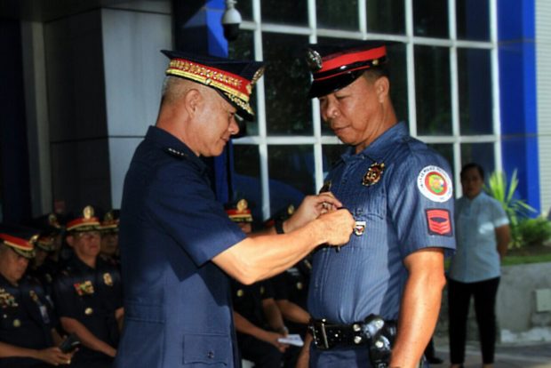 PNP chief Gen. Oscar Albayalde confers the PNP Heroism Medal to two police officers who helped rescue passengers of the M:B Chi-Chi 2
