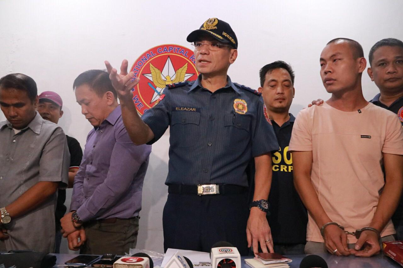 NCRPO chief Maj. Gen. Guillermo Eleazar (center) presents to the media on Friday, Sept. 6, 2019, a lawyer (second from left) and his two companions arrested for allegedly bribing police officers for the release of a Chinese national arrested for human trafficking. (Photo from NCRPO)