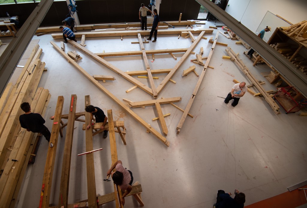 Carpenter apprentices work on a roof truss matching one of Notre-Dame de Paris Cathedral's as part of their training at the "Compagnons du Devoir" in Gennevilliers on October 3, 2019. (Photo by Eric Feferberg / AFP)