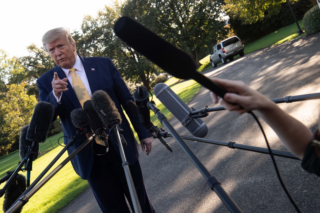US President Donald Trump speaks to the press from the South Lawn of the White House after announcing and initial deal with China in Washington, DC, prior to departing to Lake Charles, Louisiana to hold a campaign rally on October 11, 2019. - President Donald Trump on Friday hailed a breakthrough in his drawn-out trade war with China, saying the two sides reached an initial deal covering intellectual property, financial services and currencies. (Photo by NICHOLAS KAMM / AFP)
