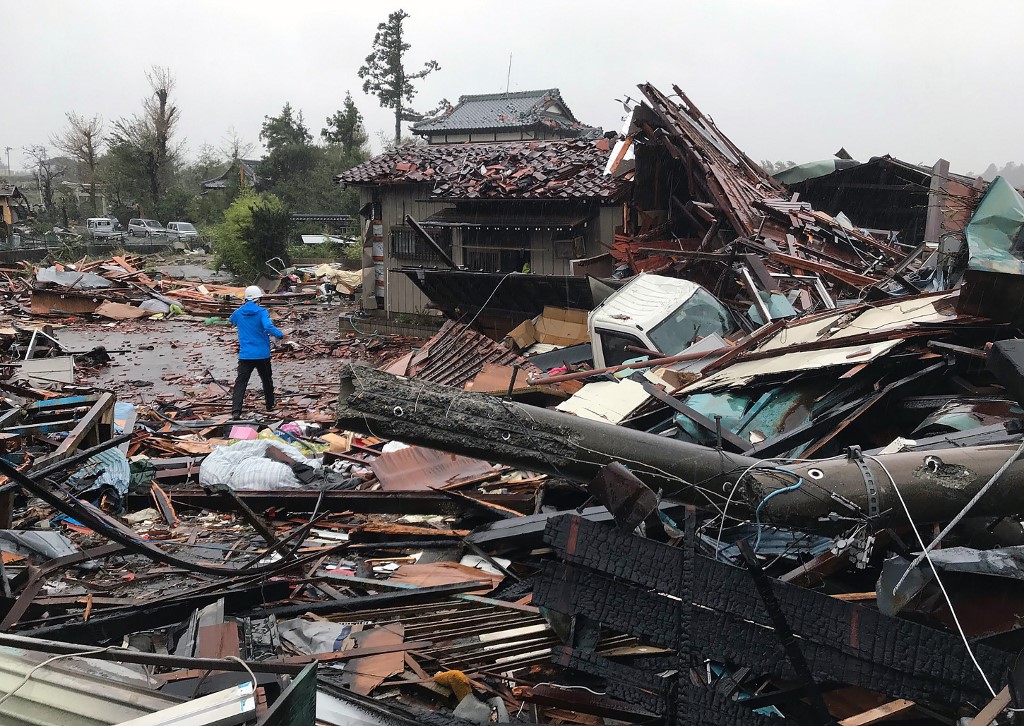 Damaged houses caused by weather patterns from Typhoon Hagibis are seen in Ichihara, Chiba prefecture on October 12, 2019. - Powerful Typhoon Hagibis on October 12 claimed its first victim even before making landfall, as potentially record-breaking rains and high winds sparked evacuation orders for more than a million people. (Photo by Jiji Press / JIJI PRESS / AFP) / Japan OUT
