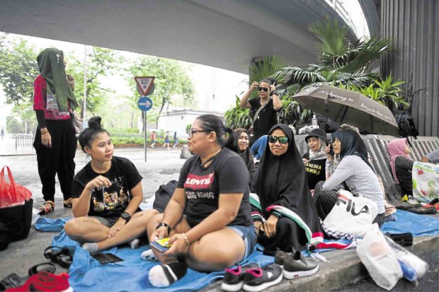 HK domestic workers dodge tear gas, clashes
