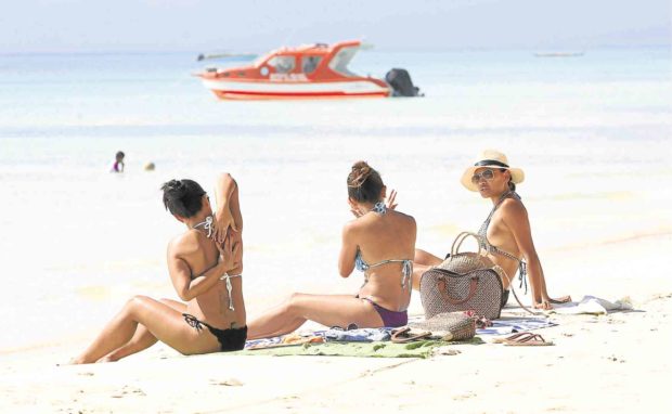 Foreign tourists on Boracay Island. STORY: Senators weigh in on VAT refund for foreign tourists