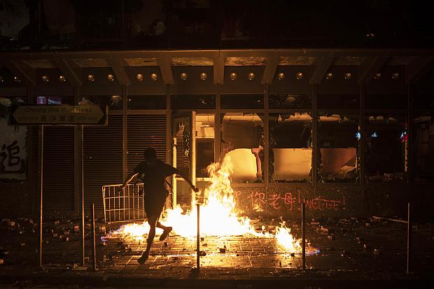 Hong Kong protester runs from burning building