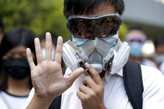 Thousands protest mask ban as HK leader toughens stance