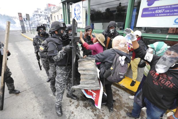 Ecuador clash site has party clowns, recycling, tear gas