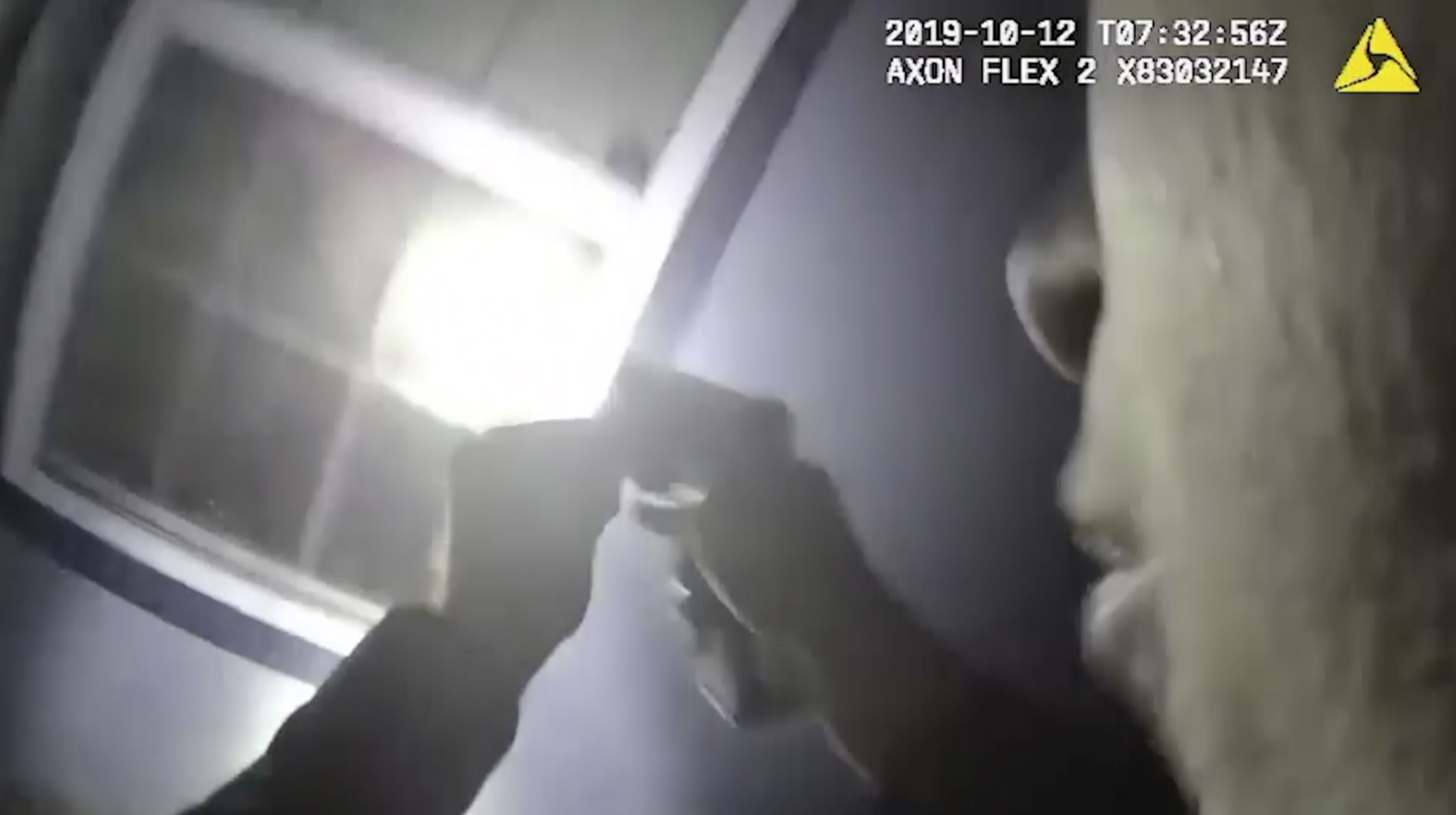In this Saturday, Oct. 12, 2019, image made from a body camera video released by the Fort Worth Police Department an officer shines a flashlight into a window in Fort Worth, Texas. A black woman was fatally shot by a white Fort Worth, Texas, officer inside the home early Saturday after police were called to the residence for a welfare check, authorities said. The Tarrant County Medical Examiner's Office identified her as 28-year-old Atatiana Jefferson. (Fort Worth Police Department via AP)