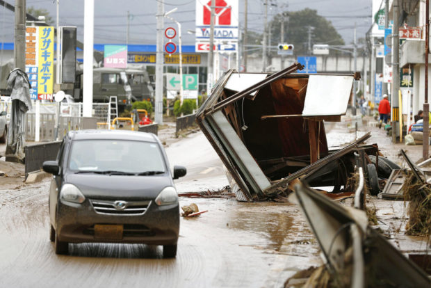 Japan looks for missing after typhoon, warned of mudslides
