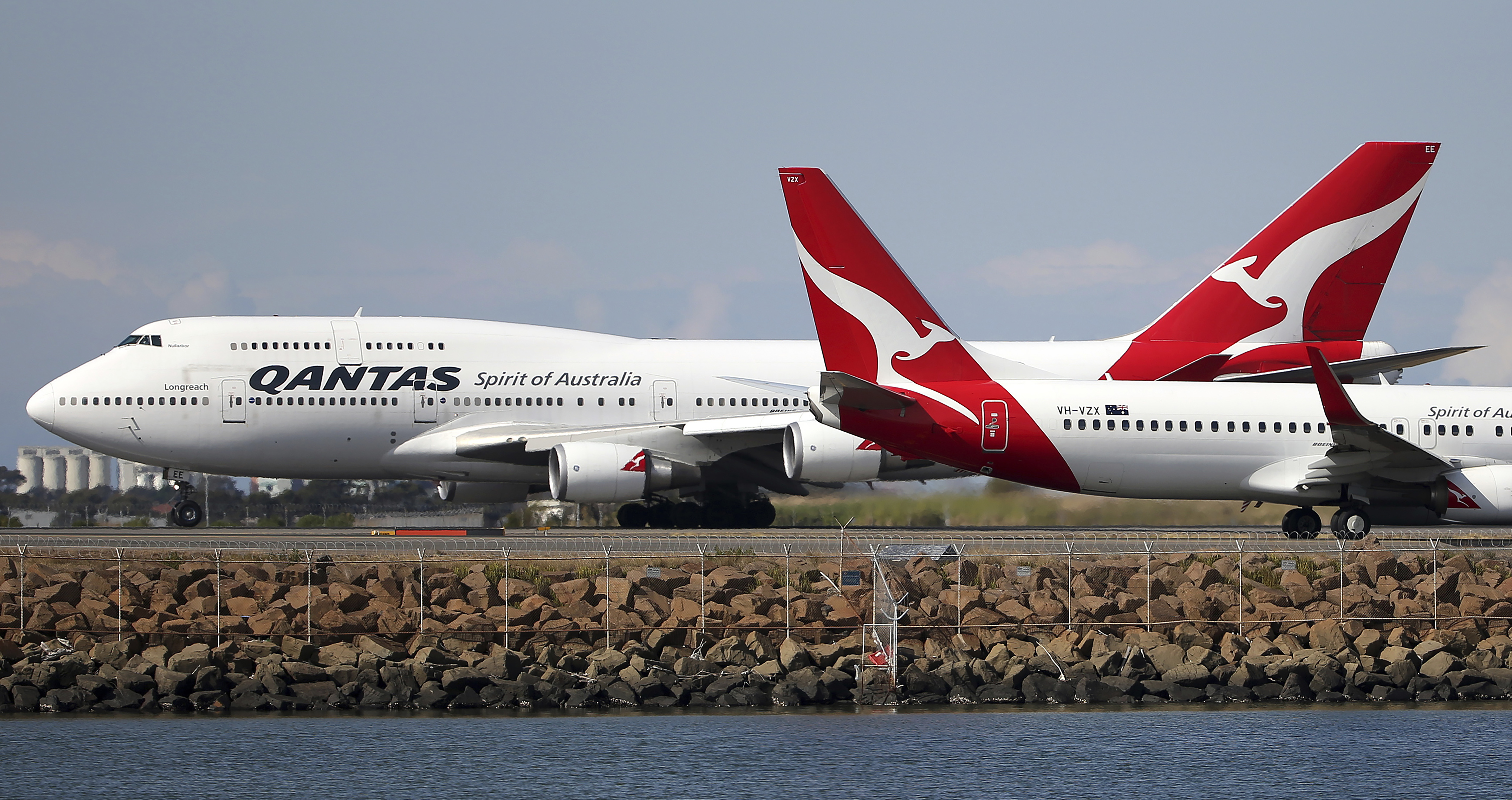 FILE - In this Aug. 20, 2015 file photo, two Qantas planes taxi on the runway at Sydney Airport in Sydney, Australia. Australia's Qantas has completed the first non-stop commercial flight from New York to Sydney Sunday, Oct. 20, 2019, which was used to run a series of tests to assess the effects of ultra-long-haul flights on crew fatigue and passenger jetlag. (AP Photo/Rick Rycroft)