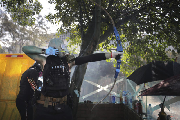 Hong Kong officer hit by arrow; police fire water cannons