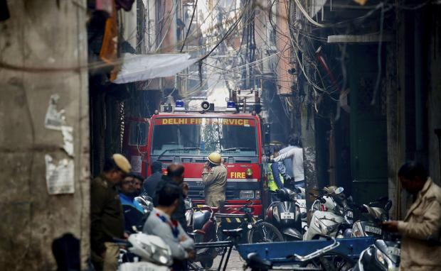 Firetruck in alleyway near fire site in New Delhi
