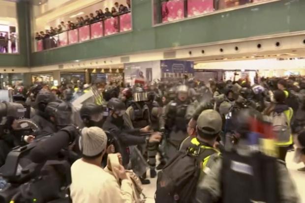 Police officers scuffle with protester in Hong Kong mall