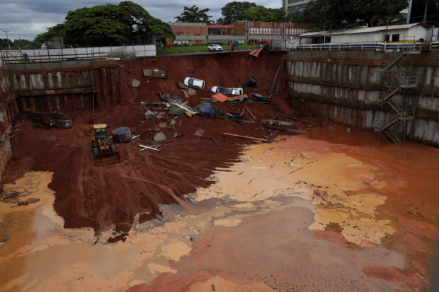  Landslide in Brazil capital spills 4 cars into building site