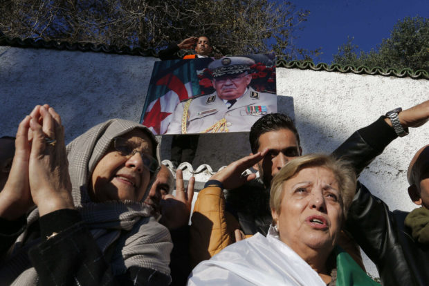Algeria buries military chief, de facto ruler amid protests