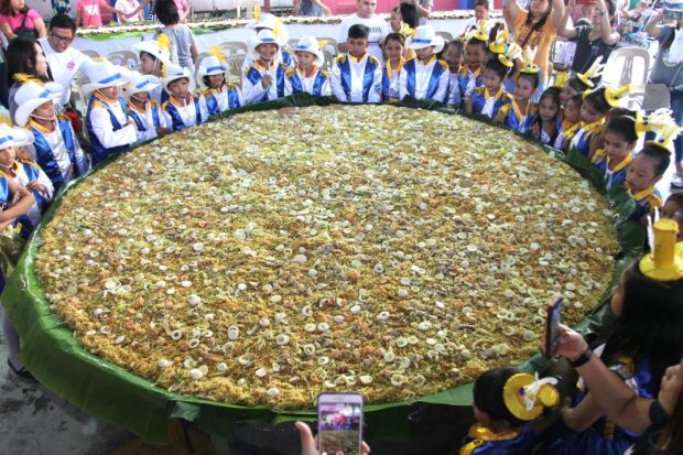 LOOK: Residents feast on giant Pancit Malabon