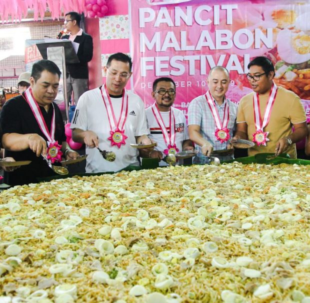 LOOK: Residents feast on giant Pancit Malabon