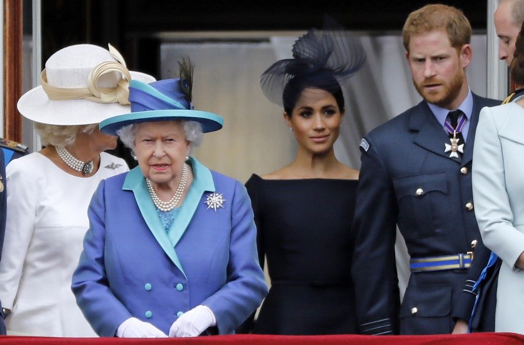 (FILES) In this file photo taken on July 10, 2018 (L-R) Britain's Camilla, Duchess of Cornwall, Britain's Queen Elizabeth II, Britain's Meghan, Duchess of Sussex, Britain's Prince Harry, Duke of Sussex, AND Britain's Prince William, Duke of Cambridge come onto the balcony of Buckingham Palace to watch a military fly-past to mark the centenary of the Royal Air Force (RAF). - Britain's Prince Harry and his wife Meghan will step back as senior members of the royal family and spend more time in North America, the couple said in a shock announcement on January 8, 2020. The surprise news follows a turbulent year for the monarchy, with signs that the couple have increasingly struggled with the pressures of royal life and family rifts. "We intend to step back as 'senior' members of the royal family and work to become financially independent, while continuing to fully support Her Majesty The Queen," they said in a statement released by Buckingham Palace. (Photo by Tolga AKMEN / AFP)
