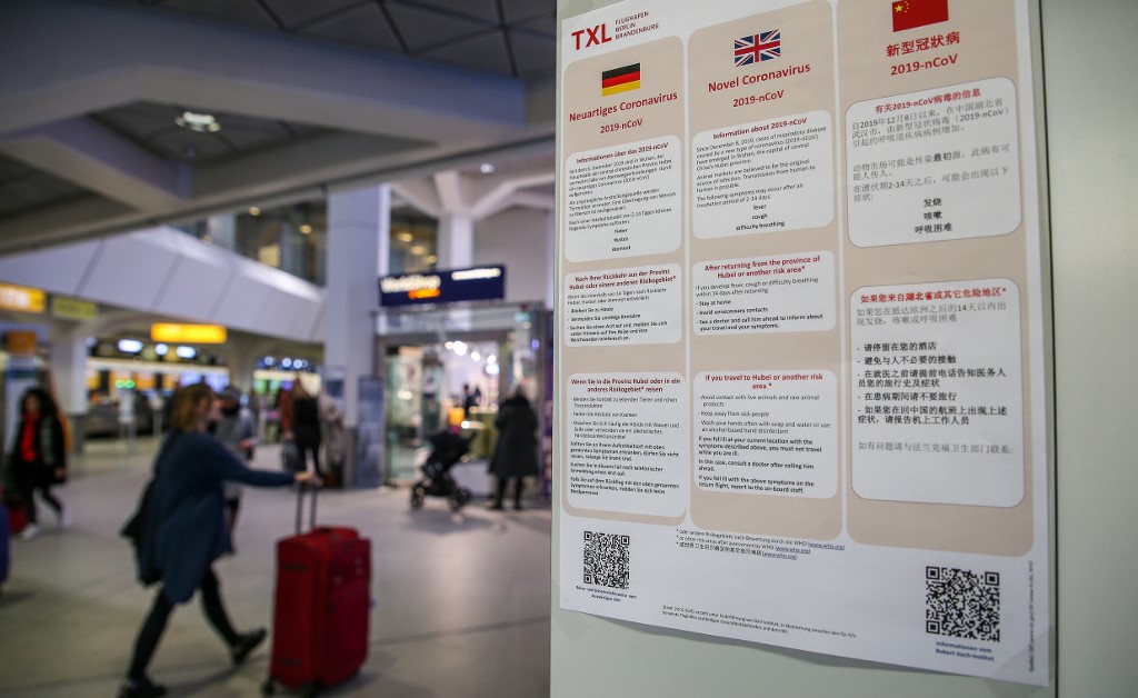 Informations in German, English and Chinese languages about the Novel Coronavirus 2019-nCoV are on display at the Tegel airport in Berlin on January 26, 2020. - A virus similar to the SARS pathogen has claimed 56 lives since emerging in a market in the central Chinese city of Wuhan, and spread around the world. (Photo by Andreas Gora / dpa / AFP) / Germany OUT