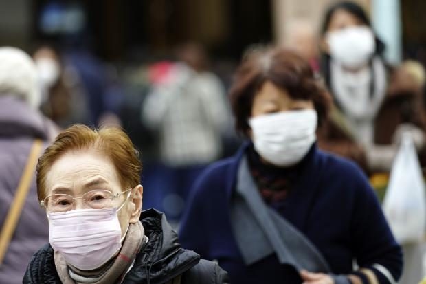 Pedestrians wearing face masks in Japan