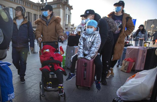 Travelers wearing face masks at Beijing Railway Station