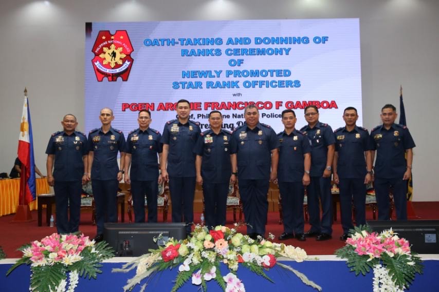 a group photo of police officers who were promoted