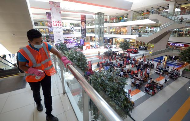  Worker sanitizes mall railing in Davao City