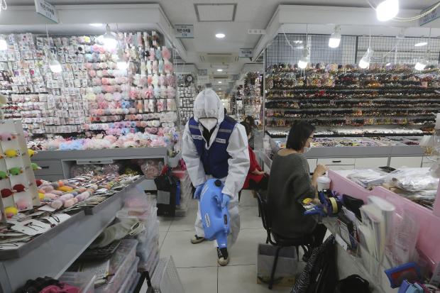 Worker in protective gear in South Korea store
