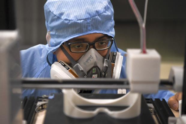 Worker at work at company producing googles for medical use