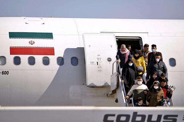  Passengers disembarking from plane in Iraq