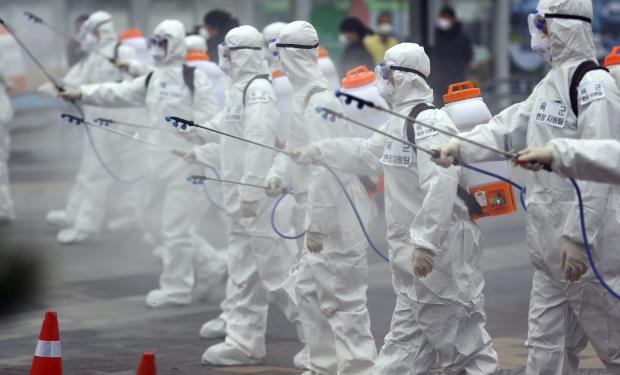 Soldiers spray disinfectant at train station in South Korea