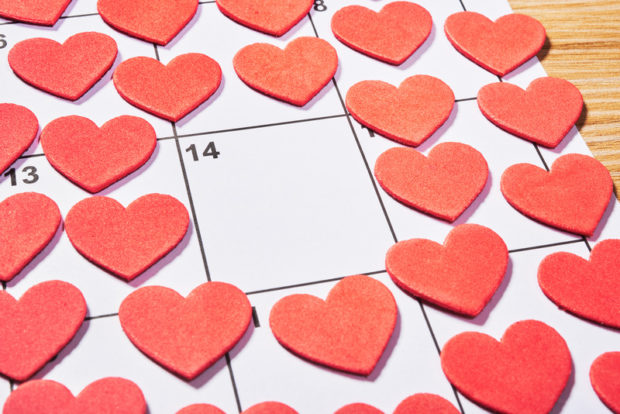 Stock photo. Cut-out hearts surrounding the number 14 in a box on a calendar. STORY: So how did Metro Manila mayors mark Valentine’s Day?