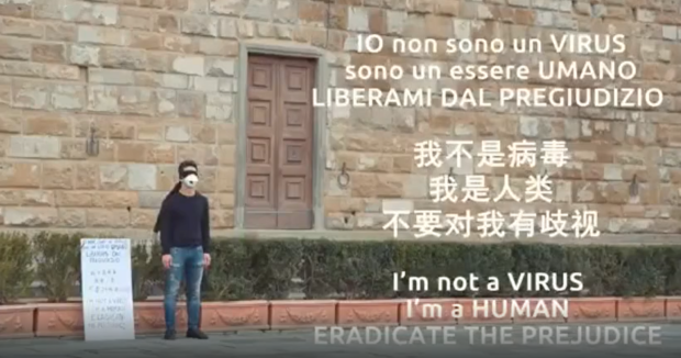 Chinese Italian who wore a face mask, with a placard reading I am not a virus, I am a human