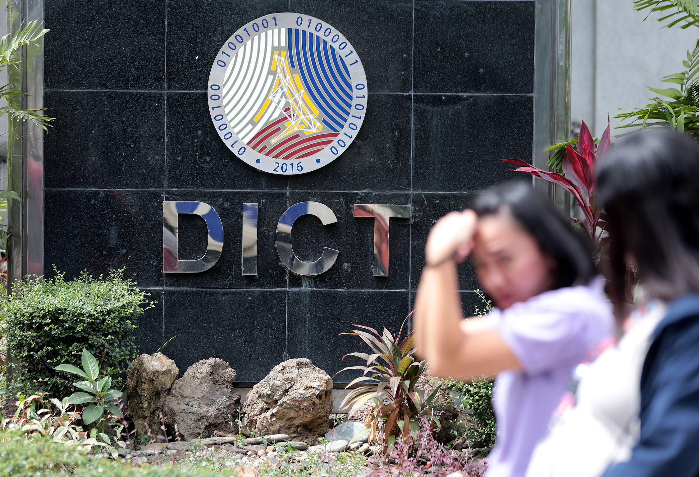 People walk past the Department of Information and Communications Technology (DICT) office on C.P. Garcia, Diliman, Quezon City in this file photo taken on February 5, 2020. INQUIRER FILE PHOTO / GRIG C. MONTEGRANDE dict